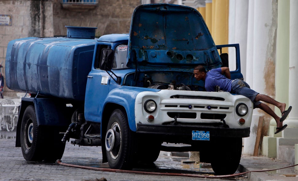2011 - A man checks the engine of his water cistern truck in Old Havana.