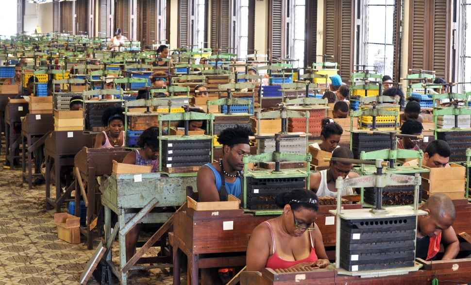 2011 - Cigar rollers work as they listen to a reader on at H. Upmann Cigar Factory in Havana. The tradition of cigar factory 