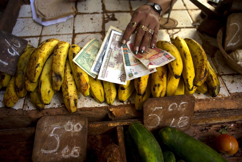 2013 - A food vendor spreads out bananas. Cuba is the only country in the world that mints two national currencies, a bizarre