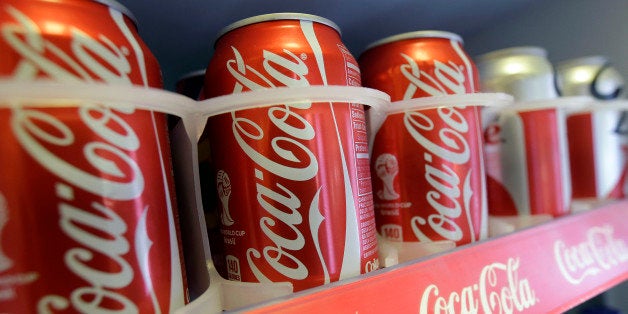 In this June 30, 2014 photo cans of Coca-Cola soda pop are shown in the refrigerator inside of Chile Lindo in San Francisco. San Francisco and Berkeley are aiming to become the first U.S. cities to pass per-ounce taxes on sugary drinks. (AP Photo/Jeff Chiu)