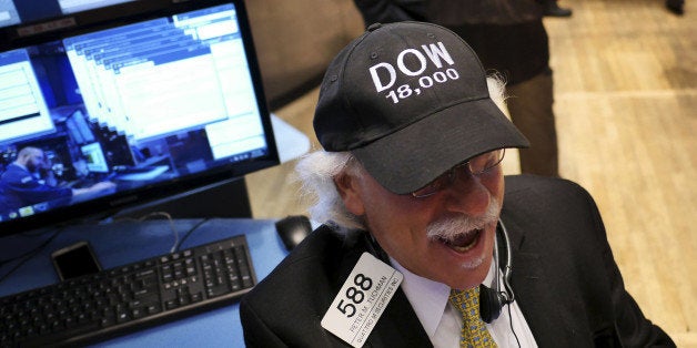 Peter Tuchman wears a "DOW 18,000" hat on the floor at the New York Stock Exchange in New York, Tuesday, Dec. 23, 2014. U.S. stocks pushed further into record territory on Tuesday as the Dow Jones industrial average crossed past the 18,000-point mark for the first time. (AP Photo/Seth Wenig)