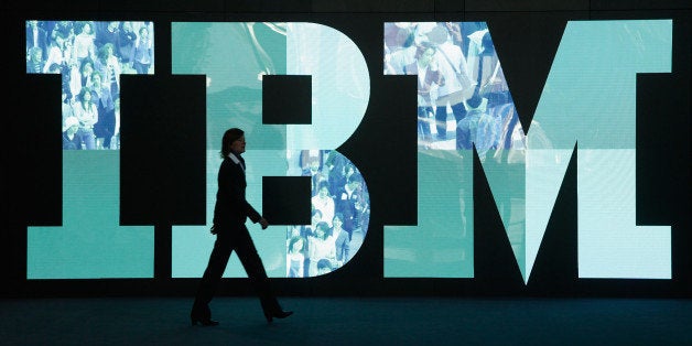 HANOVER, GERMANY - FEBRUARY 28: A woman walks past the IBM logo at the CeBIT technology trade fair the day before the fair's