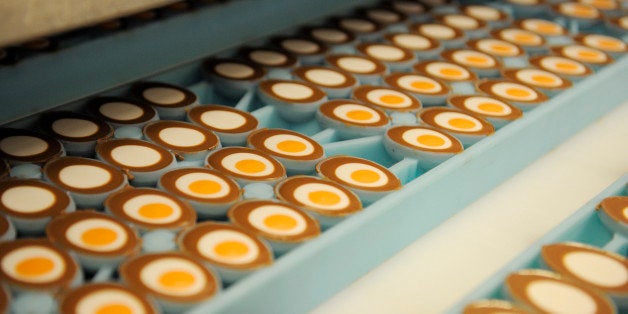 Cadbury's Creme Egg moulds move down the production line at the Cadbury Plc factory in Birmingham, U.K., on Friday, Nov. 20, 2009. Cadbury Plc should pool assets with Hershey Co. to create a company with dual listings in New York and London and fend off Kraft Foods Inc.ï¿½s advance, according to Richard Royden, a strategist at GFI Group Inc. in London. Photographer: Frantzesco Kangaris/Bloomberg via Getty Images