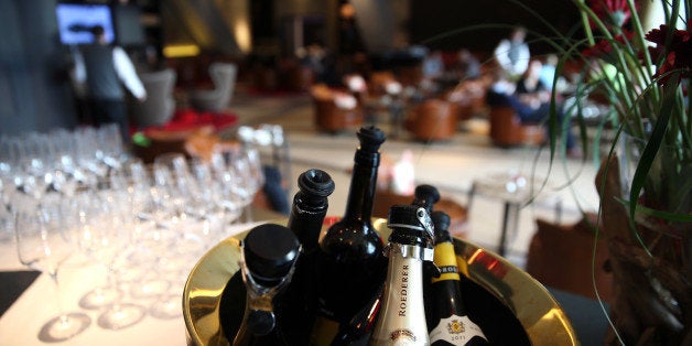 A bottle of Louis Roederer champagne sits in a ice bucket at the 'Nuts & Co' bar at the InterContinental hotel Davos, operated by InterContinental Hotels Group Plc (IHG) in Davos, Switzerland, on Saturday, Jan. 18, 2014. Next week the business elite will gather in the Swiss Alps for the 44th annual meeting of the World Economic Forum (WEF) in Davos for the five day event which runs from Jan. 22-25. Photographer: Simon Dawson/Bloomberg via Getty Images