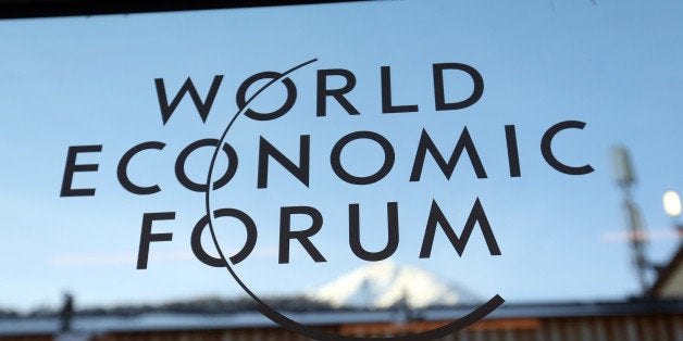 A logo sits on a glass panel inside the Kongress Zentrum, also known as Congress Center, the venue of the World Economic Forum (WEF) in Davos, Switzerland, on Monday, Jan. 19, 2015. This week World leaders, influential executives, bankers and policy makers will attend the 45th annual meeting of the World Economic Forum in Davos that runs from Jan. 21-24. Photographer: Chris Ratcliffe/Bloomberg via Getty Images