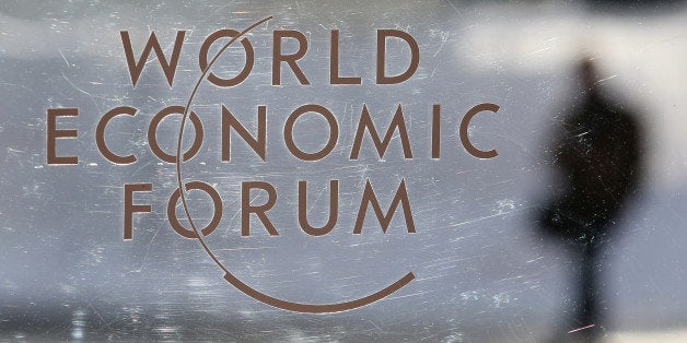 A logo sits on a glass panel inside the Kongress Zentrum, also known as Congress Center, the venue of the World Economic Forum (WEF) in Davos, Switzerland, on Monday, Jan. 19, 2015. This week World leaders, influential executives, bankers and policy makers will attend the 45th annual meeting of the World Economic Forum in Davos that runs from Jan. 21-24. Photographer: Chris Ratcliffe/Bloomberg via Getty Images