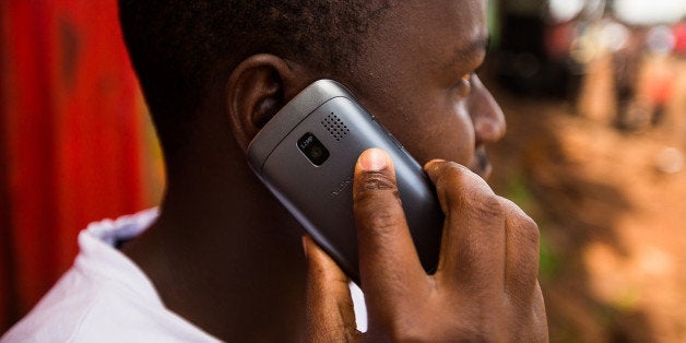 A resident speaks on a Nokia Asha mobile phone on a street in Nairobi, Kenya, on Sunday, April 14, 2013. In the six years since Kenya's M-Pesa brought banking-by-phone to Africa, the service has grown from a novelty to a bona fide payment network. Photographer: Trevor Snapp/Bloomberg via Getty Images