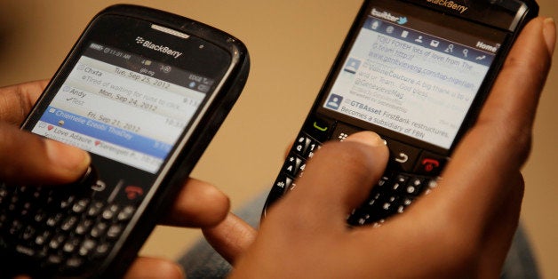An Unidentified woman twits with her black berries during a press conference in Lagos, Nigeria. Tuesday, Sept. 25, 2012. Th