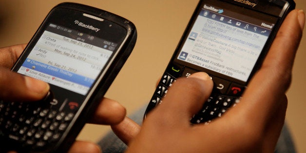 An Unidentified woman twits with her black berries during a press conference in Lagos, Nigeria. Tuesday, Sept. 25, 2012. The company that makes BlackBerry smartphones is looking to Africa to help its troubled sales.Officials with Toronto-based Research In Motion Ltd. told journalists in Lagos on Tuesday that its handsets are the No. 1 choice among those using smartphones in Nigeria and South Africa. Officials say that in Nigeria alone, its phones represent one out of every two phones in the market, an incredible grip on the market of Africa's most populous nation. BlackBerry phones remain such a pop culture fascination in Nigeria that it spawned a popular local film "BlackBerry Babes." .(AP Photo/Sunday Alamba)