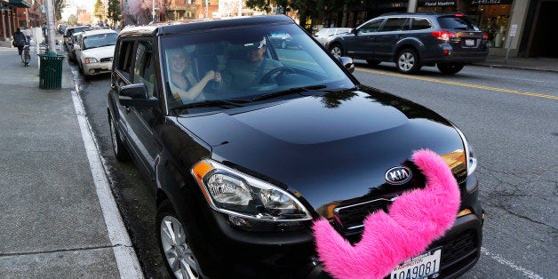 In this March 12, 2014 photo, passenger Katie Baranyuk, left, and Dara Jenkins, right, a driver for the ride-sharing service
