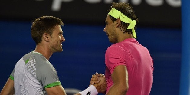 Spain's Rafael Nadal (R) shakes hands after victory in his men's singles match against Tim Smyczek of the US on day three of the 2015 Australian Open tennis tournament in Melbourne on January 21, 2015. AFP PHOTO / PAUL CROCK -- IMAGE RESTRICTED TO EDITORIAL USE - STRICTLY NO COMMERCIAL USE (Photo credit should read PAUL CROCK/AFP/Getty Images)