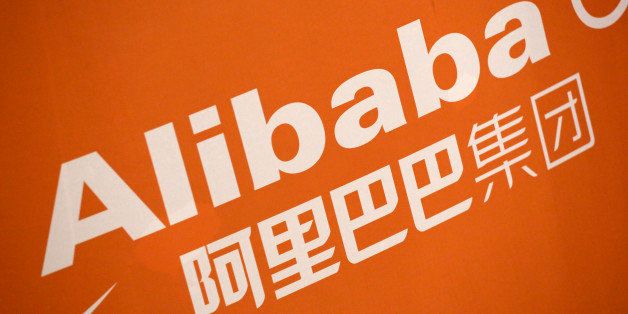 FILE - In this Sept. 19, 2014 file photo, the Alibaba logo is displayed during the company's IPO at the New York Stock Exchange, in New York. On Thursday, Jan. 29, 2015, Alibaba Group said its net income fell as it faced higher one-time costs but its adjusted earnings beat expectations. (AP Photo/Mark Lennihan, File)