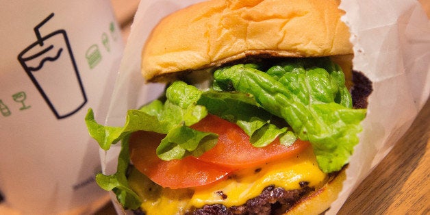 CHICAGO, IL - JANUARY 28: In this photo illustration a cheeseburger is served up at a Shake Shack restaurant on January 28, 2015 in Chicago, Illinois. The burger chain, with currently has 63 locations, is expected to go public this week with an IPO priced between $17 to $19 a share. The company will trade on the New York Stock Exchange under the ticker symbol SHAK. (Photo Illustration by Scott Olson/Getty Images)