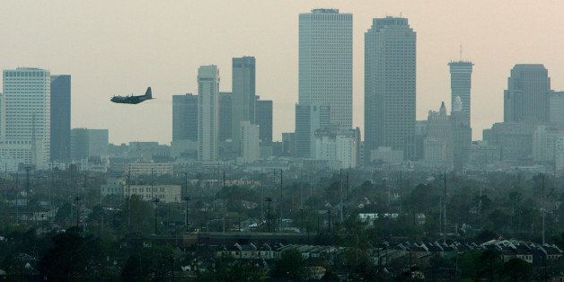 NEW ORLEANS - SEPTEMBER 13: A U.S. Air Force C-130 plane flys near the New Orleans skyline as it sprays pesticide September 13, 2005 in New Orleans, Louisiana. Pesticide was sprayed over areas with standing water that are expected to breed large numbers of mosquitos. Rescue efforts and clean up continue in the areas hit by Hurricane Katrina over two weeks after the deadly storm hit. (Photo by Justin Sullivan/Getty Images)