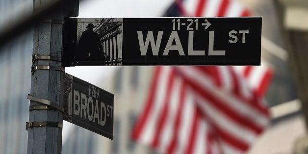 A Wall Street road sign is pictured near the New York Stock Exchange (NYSE) building on October 16, 2014 in New York. US stoc