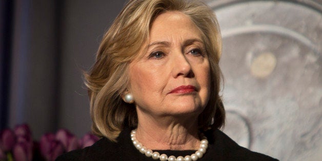 FILE - In this Friday, Nov. 21, 2014, file photo, Hillary Rodham Clinton listens before delivering remarks at an event in New York. Clinton has offered praise for President Barack Obamaâs executive actions to stave off deportation for millions of immigrants living in the U.S. illegally. But the Democratsâ favored presidential hopeful has been less forthcoming on other issues in these early days of the 2016 contest. Clinton is not, so far, a candidate, and sheâs limiting her commentary about the daily news cycle confronting Obama. (AP Photo/Bebeto Matthews, File)