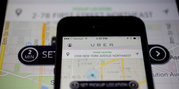 The Uber Technologies Inc. application is displayed on an Apple Inc. iPhone 5s and iPad Air in this arranged photograph in Washington, D.C., U.S., on Wednesday, March 5, 2014. Uber, a startup that lets drivers pick up passengers with their personal cars and that was valued at $3.5 billion in a funding round last year, has raised $307 million from a group of backers that include Google Ventures, Google Inc.'s investment arm, and Jeff Bezos, the founder of Amazon. Photographer: Andrew Harrer/Bloomberg via Getty Images