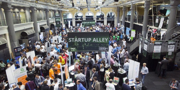 Exhibitors promote their business start-up companies in the main hall titled 'Startup Alley' at the Disrupt Europe 2014 conference in London, U.K., on Monday, Oct. 20, 2014. The TechCrunch event features representatives from global start-up companies involved in industries including medical diagnostics, enterprise mobile tools, and financial technology. Photographer: Jason Alden/Bloomberg via Getty Images