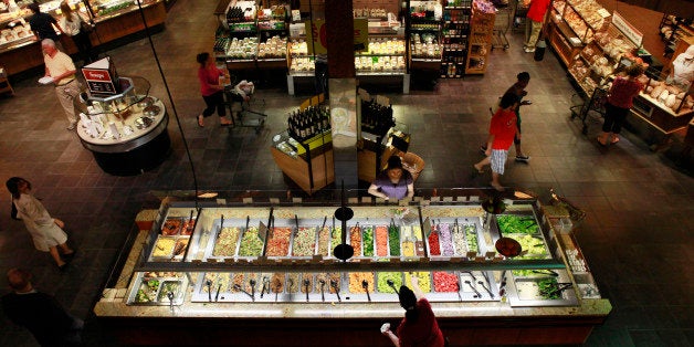 Customers shop at the salad bar for lunch at the Market Cafe in the Wegmans grocery store in Fairfax, Va., Thursday, May 27, 2010. The prepared supermarket food available today is a far cry from the modest offerings of fresh coffee, potato salad and rotisserie chickens of years past. (AP Photo/Jacquelyn Martin)