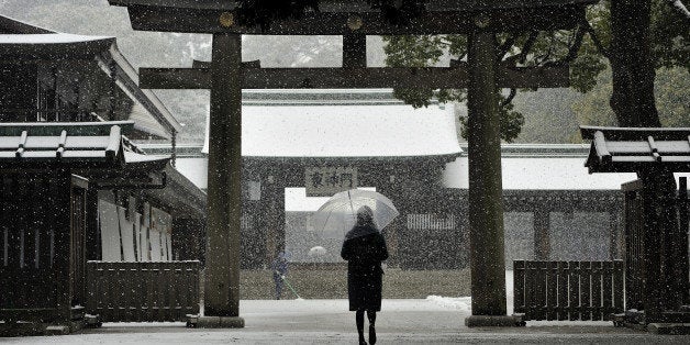 TOKYO, JAPAN - JANUARY 30: A woman walks through the park of the Meiji Jingu shrine covered with snow in Tokyo, Japan on January 30, 2015. While rail traffic is disrupted, some Japanese take the opportunity to go for a walk in the park or visit temples covered with snow, and for some people taking pictures in front of the Imperial Palace to shoot the first snowfall of the year in the capital. (Photo by David Mareuil/Anadolu Agency/Getty Images)