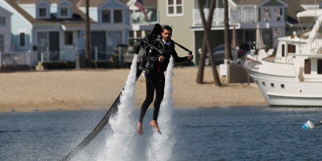 Grant Engler is airborne as he flies in a jet pack suit into his wedding ceremony Thursday, Aug. 23, 2012 in Newport Beach, Calif. The couple donned the (Canadian) $90,000 (C72,000) contraptions on their backs, along with a wetsuit for the groom and white board shorts and a rash-guard shirt for the bride. The jet packs from Jetlev Southwest helped the couple hover a few feet above the water, to the cheers of their wedding guests. Everything went smoothly, except for a kayaker who capsized during the newlyweds' first dance on the water. (AP Photo/Lenny Ignelzi)