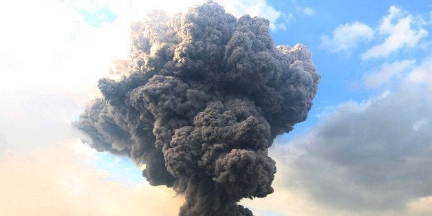 SUMATRA, INDONESIA - OCTOBER 13: Mount Sinabung spews pyroclastic smoke, seen from Tiga Pancur village in Karo district of North Sumatra, Indonesia on October 13, 2014. Activity of Mount Sinabung volcano is high the alert status III, the presence of 142 avalanches earthquakes accompanied the eruption of pyroclastic flow recurrent times with a height of 4.5 kilometers down the slopes that threaten civilian villages. (Photo by Kharisma Tarigan/Anadolu Agency/Getty Images)