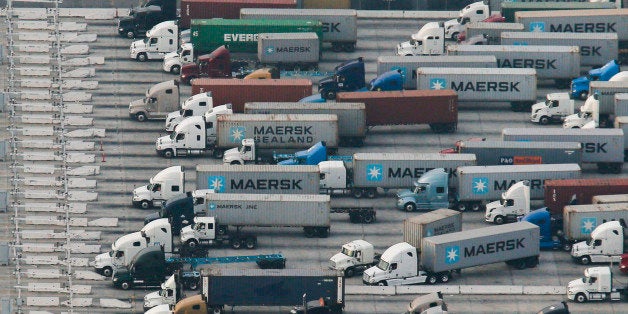 Trucks transporting A.P. Moeller-Maersk A/S branded containers wait in line with other trucks in this aerial photograph taken above the Port Los Angeles in Los Angeles, California, U.S., on Wednesday, Feb. 18, 2015. United Steelworkers members who help run crude terminals at a California port are threatening to join a national oil workers' strike at U.S. refineries. Photographer: Patrick T. Fallon/Bloomberg via Getty Images