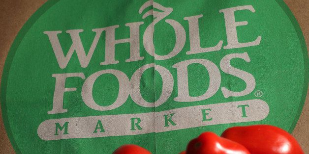 FILE - In this Monday, July 29, 2013, file photo, produce is places on Whole Foods paper bag in Andover, Mass. Whole Foods Market Inc. reports quarterly financial results after the market closes on Wednesday, Nov. 6, 2013. (AP Photo/Elise Amendola, File)