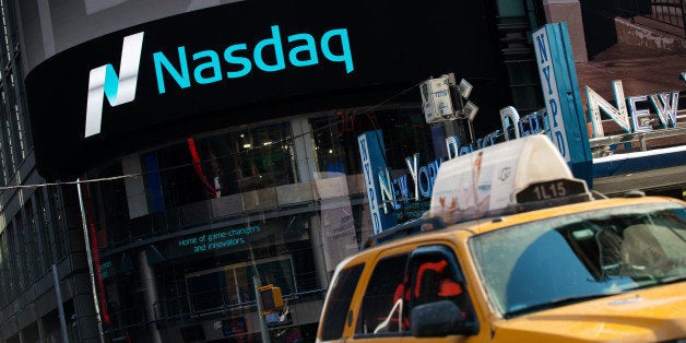 NEW YORK, NY - MARCH 02: Cars drive past the NASDAQ MarketSite on March 2, 2015 in New York City. The NASDAQ composite climbed over 5,000 points for the first time in 15 years when it briefly peaked over 5,000 points at 10:30 a.m. ET.(Photo by Bryan Thomas/Getty Images)