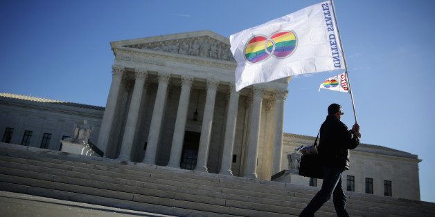 WASHINGTON, DC - JANUARY 09: Pete Prete of Equality Beyond Gender holds a 'marriage pride flag' outside the U.S. Supreme Court January 9, 2015 in Washington, DC. The justices of the Supreme Court were scheduled to meet to determine whether the court will take up any of the five pending state-banned same-sex marriage cases in Ohio, Tennessee, Michigan, Kentucky and Louisiana. (Photo by Alex Wong/Getty Images)