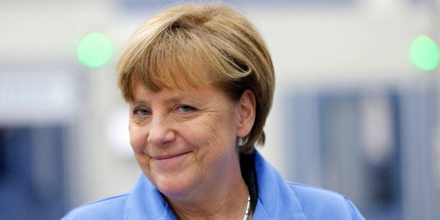 German Chancellor Angela Merkel smiles during her visit to the Siemens electronics manufacturing plant in Amberg, Germany, Monday, Feb. 23, 2015. (AP Photo/Michael Probst)