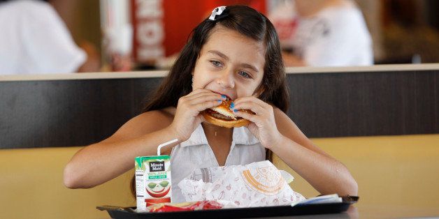 Paolo Beldran eats a healthy choice meal at a south Miami Burger King Tuesday, July 12, 2011. Parents seeking healthier restaurant meals for their kids At least 19 large restaurant chains _ including Burger King, Chili's, IHOP and Friendly's _ plan to announce Wednesday that they will add healthier options to their children's menus. At least 15,000 restaurant locations will focus on increasing servings of fruits and vegetables, lean proteins, whole grains and low fat dairy. The new items will have less fats, sugars and sodium. (AP Photo/J Pat Carter)