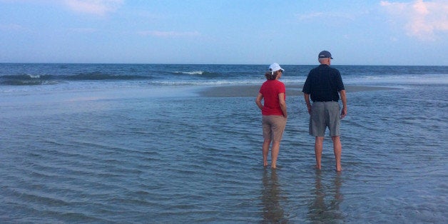 Senior couple wading at the beach , Jacksonville Beach, Florida , USA on August 17 , 2014.
