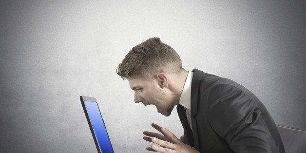 Businessman with blue screen of laptop error