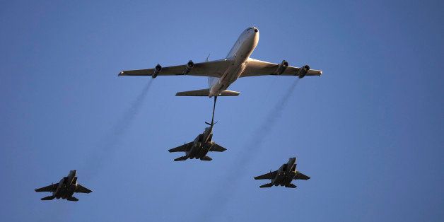 An Israeli Air Force Boeing 707 demonstrates refueling of an F15 fighter jet during a graduation ceremony for new pilots in the Hatzerim air force base near the city of Beersheba, southern Israel, Thursday, Dec. 25, 2014. (AP Photo/Tsafrir Abayov)