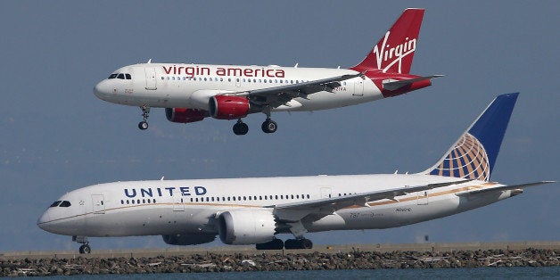 SAN FRANCISCO, CA - FEBRUARY 18: A Virgin America plane lands above a United Airlines plane at San Francisco International Airport on February 18, 2015 in San Francisco, California. Virgin America has reported a full year profit of $60.1 million and fourth quarter earnings of 3.9 million compard to $14.1 million one year ago. (Photo by Justin Sullivan/Getty Images)