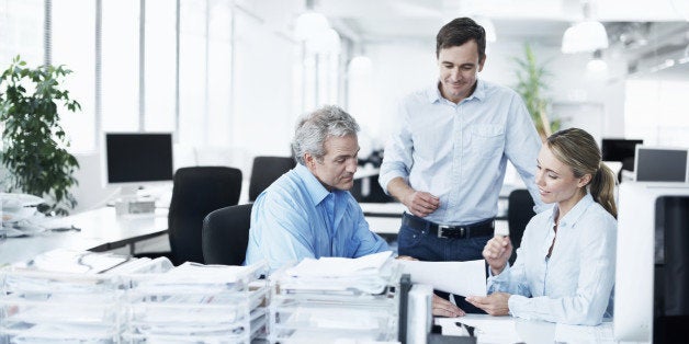 Three businesspeople working together in their office