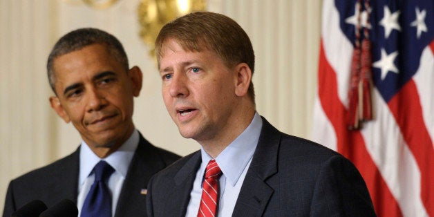 President Barack Obama, left, listens as Richard Cordray, right, the new director of the Consumer Financial Protection Bureau, speaks in the State Dining Room of the White House in Washington, Wednesday, July 17, 2013. The Senate voted on Tuesday, July 16, 2013, to end a two-year Republican blockade that was preventing Cordray from winning confirmation as director of the Consumer Financial Protection Bureau. (AP Photo/Susan Walsh)