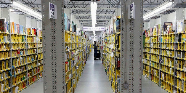 FILE - In this Monday, Dec. 2, 2013, file photo, an Amazon.com employee stocks books at the Amazon.com Fulfillment Center in
