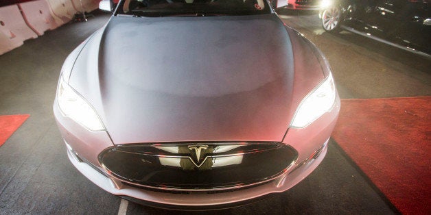 FILE - In this Oct. 9, 2014 photo, a guest test drives Tesla Motors' new version of its Model S sedan, the P85D, in Hawthorne, Calif. Tesla Motors Inc. reports quarterly financial results after the market closes Wednesday, Nov. 5, 2014. (AP Photo/Ringo H.W. Chiu, File)