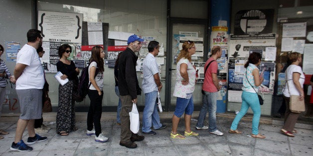 Jobseekers queue to enter an OAED employment center shortly after opening in Athens, Greece, on Wednesday, Sept. 10, 2014. Ov