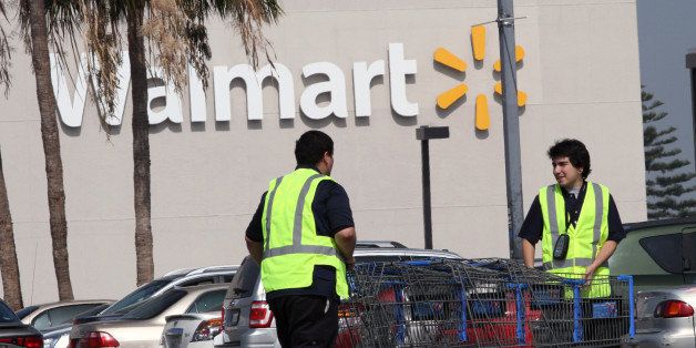 LOS ANGELES, CA - FEBRUARY 19: Workers retrieve shopping carts at the Crenshaw Plaza parking lot near the Wal-Mart on February 19, 2015 in Los Angeles, California. Wal-Mart Stores Inc. announced today that it was increasing employee's wages in the U.S. to at least $9 an hour, $1.75 above the federal minimum wage, to take affect in April. (Photo by Bob Chamberlin/Los Angeles Times via Getty Images)