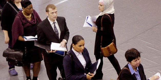 FILE - In this Oct. 8, 2014 file photo, job hunters line up for interviews at an employment fair sponsored by the New York State Department of Labor, in the Brooklyn borough of New York. Associated Press-GfK poll finds Americans' views of Obama have improved slightly in the past two months, as have opinions on the direction of the country and the strength of the economy. Bump up for his handling of unemployment. (AP Photo/Mark Lennihan, File)