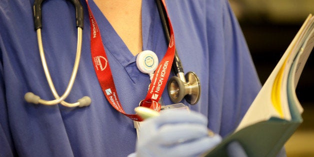 BIRMINGHAM, ENGLAND - JANUARY 22: Editors Note: This image may have been digitally manipulated for confidentiality to remove any patient identidy data. Theatre staff perform a surgical procedure in the operating theatre at Birmingham Women's Hospital on January 22, 2015 in Birmingham, England. Birmingham Womens Hospital provides a range of health services to women and their families using the latest scientific procedures and care. Last year the maternity unit delivered over 8,000 babies, cared for 50,000 patients and performed over 3000 procedures in its state of the art theatres. The hospital is also home to world renowned research scientists, fertility clinic and the national sperm bank. (Photo by Christopher Furlong/Getty Images)