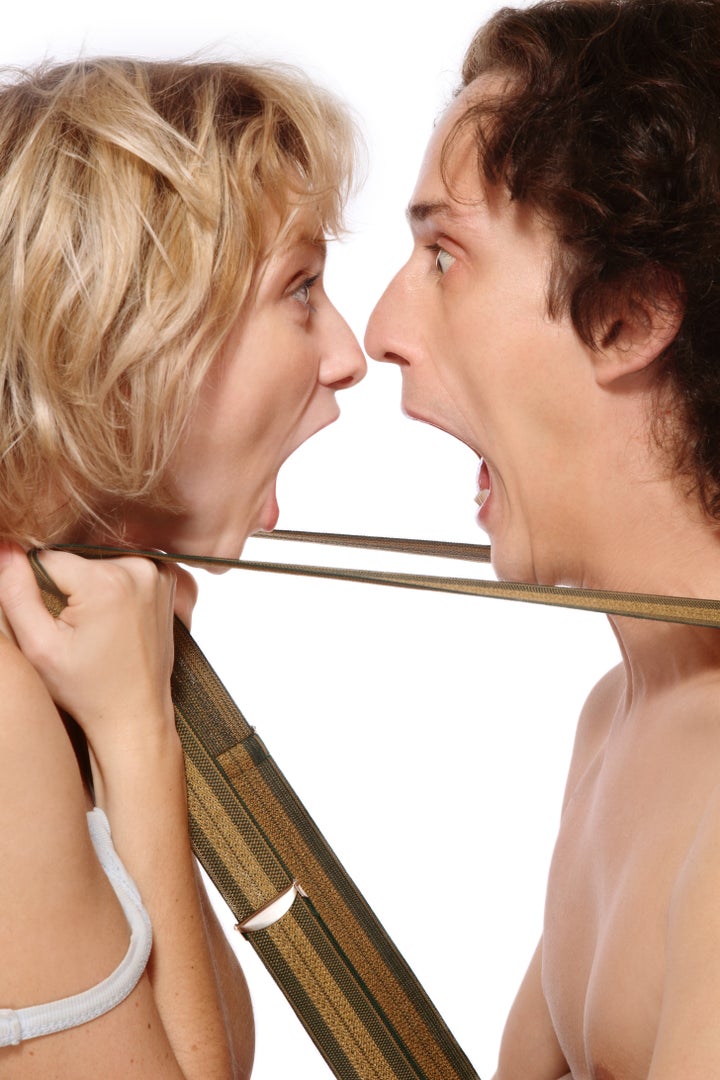 Emotional shot of young man and woman crying to each other