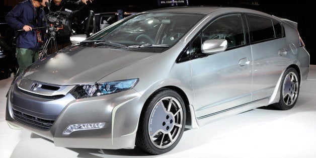 Cameramen video a customized Honda hybrid 'Insight Sports Modulo Concept' car at the Tokyo Auto Salon 2010 in Chiba, suburb T