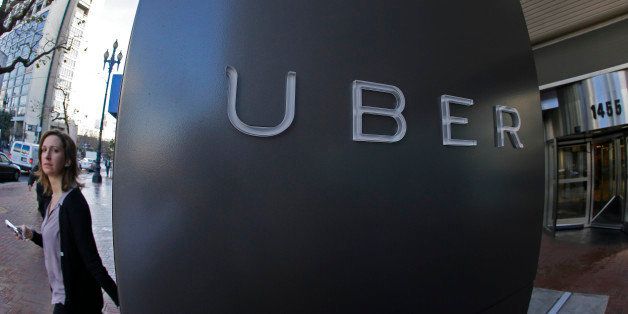 In this Tuesday, Dec. 16, 2014 photo, a woman leaves the headquarters of Uber in San Francisco. Venture capitalists poured a whopping $48.3 billion into U.S. startup companies last year, investing at levels that haven't been seen since before the dot-com bubble burst in 2001, according to a new report issued Friday, Jan. 16, 2015. The two biggest deals in 2014 were separate rounds of investment in Uber Technologies, the high-flying and controversial ride-hailing service, now valued at $41 billion. (AP Photo/Eric Risberg)