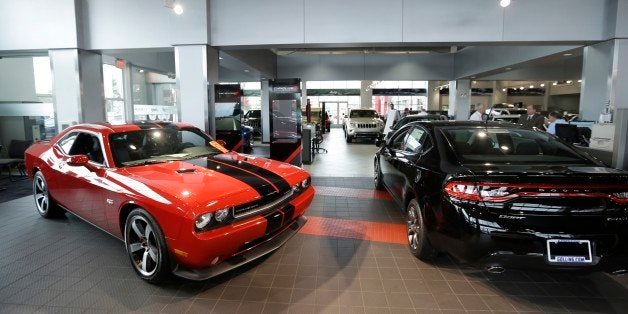 A Dodge Challenger, left, and a Dodge Dart are on display at the Golling Chrysler Dodge Jeep Ram dealership in Bloomfield Hills, Mich., Tuesday, Oct. 22, 2013. Starting Dec. 15, people will pay less in sales tax on a car purchase in Michigan because the value of your trade-in can be counted under a deal between lawmakers and Gov. Rick Snyder. (AP Photo/Carlos Osorio)