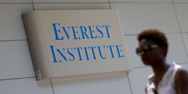 FILE - In this July 8, 2014 file photo, a woman walks past the Everest Institute in Silver Spring, Md. Corinthian Colleges, which owns Everest, Heald College and WyoTech schools, is being sued by the federal Consumer Financial Protection Bureau for what it calls a âpredatory lending scheme,â the agency said Tuesday, Sept. 16, 2014. (AP Photo/Jose Luis Magana, File)