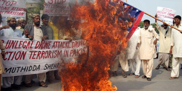 A Pakistani protesters from United Citizen Action burn the US flag during a protest against US drone attacks in Pakistani tribal areas, in Multan on October 31, 2013. A US drone strike targeting a militant compound killed three insurgents in a northwest Pakistan tribal region near the Afghan border, officials said. The incident comes a week after Pakistani Prime Minister Nawaz Sharif urged US President Barack Obama to stop drone strikes during a meeting in Washington. AFP PHOTO / S.S MIRZA (Photo credit should read S.S MIRZA/AFP/Getty Images)